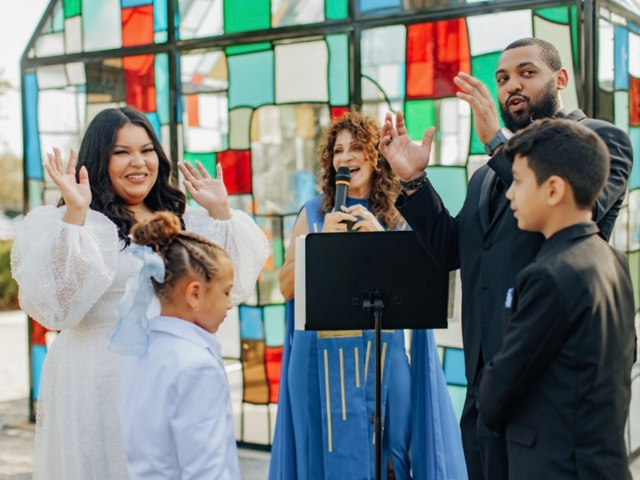 Hands lifted in joy at the close of a ceremony